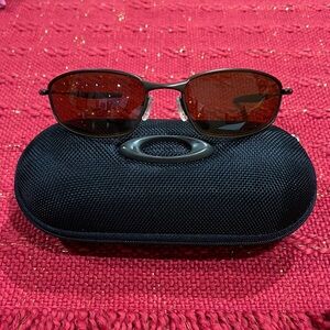 Oakley Sunglasses with Black Frame and Red Lenses